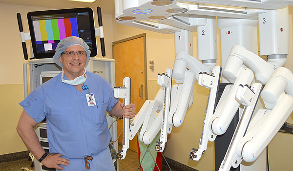 Surgeons throughout Catholic Health such as colorectal specialist Dr. Matthew Cywinski, use the da Vinci robot for a variety of surgical procedures. (Courtesy of Catholic Health)