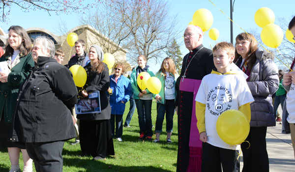 Bishop Richard J. Malone joins with other marchers outside at the conclusion of the Rosary Novena for Life Mass at St. Rose of Lima Parish. The marchers then walked silently to pray outside a Main Street abortion clinic. (Patrick McPartland/Staff Photographer)