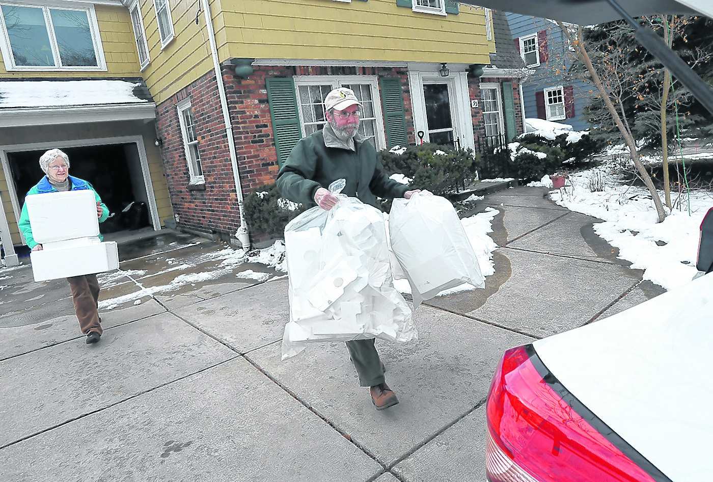 Mary and Peter Grace, parishioners from St. John the Baptist, load their truck with Styrofoam they collected during Mass at the Kenmore church. (Dan Cappellazzo/Staff Photographer)