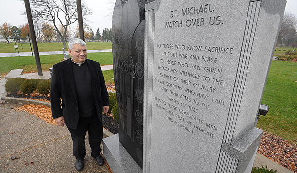 Standing before the Veterans Memorial at Mt. Olivet Cemetery, Joseph Porpiglia served as a chaplain in the U.S. Navy and ministered to those in the armed forces. (Patrick McPartland/Staff Photographer)