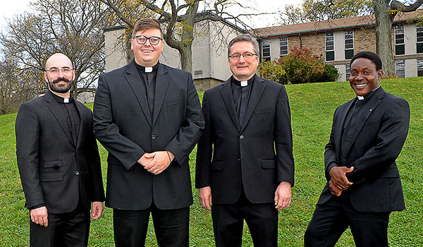 The transitional deacons Deacon Peter Santandreu (from left), Deacon Paul Cygan, Deacon Gerard Skrzynski and Deacon Peter Bassey take a break from their studies outside of Christ the King Seminary in East Aurora. (Dan Cappellazzo/Staff Photographer)
