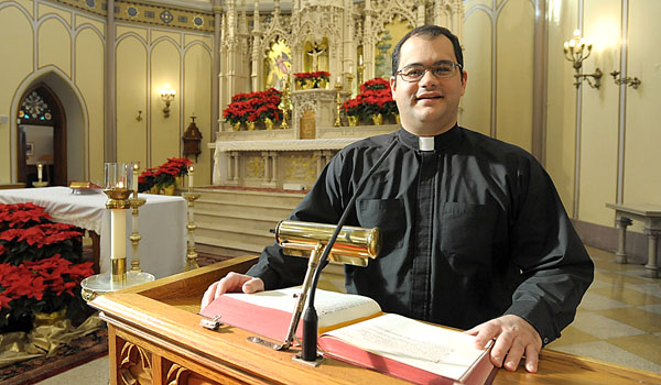 Diocesan Vocations Director Father Andrew Lauricella is looking for men to take a place at the podium and preach the word of God. (Patrick McPartland/Staff Photographer)