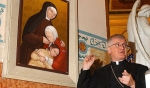Auxiliary Bishop Edward M. Grosz unveils the new icon of Mother Angela Truszkowska, founder of the Felician Sisters. The icon, which is a painting depicting Mother Angela during three stages of her life (childhood, religious life, and old age), will hang