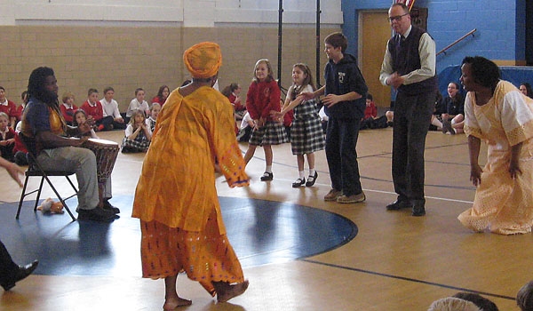 Dancers and a drummer from the African-American Cultural Center lead the Immaculate Conception community in exploring African dance.
(Courtesy of Immaculate Conception School)