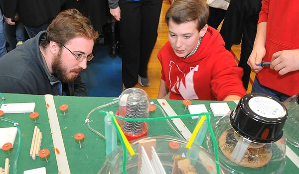 Nativity of Our Lord student Aidan Hart-Nova (right), shows the model of Corvallis City to University at Buffalo student Matthew Austin during the Western New York Regional Future City Competition. The competition was held at Mt. St. Mary Academy.
(Patrick McPartland/Staff Photographer)