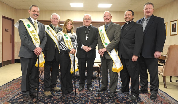 Bishop Richard J. Malone (center) is asked once again to participate in the 2015 St. Patrick's Day Parade. Members of the United Irish-American Association gathered at the Chancery to make their request. Joining the bishop are Chris Laffler Sergeant at Arms UIAA, Michael O'Sullivan Executive Committee Member UIAA, Denice Morrison Grand Marshal of the 75th Parade, John Morrison Chairman of the UIAA Executive Committee, Deputy Grand Marshal and Husband of the Grand Marshal, Father David Richards Chaplain UIAA and Patrick Plunkett Executive Committee Member UIAA.
(Patrick McPartland/Staff Photographer)