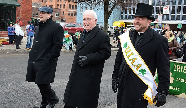 Father Ryszard Biernat (left to right), Bishop Richard J. Malone and Father David Richards help to lead the annual St. Patrick's Day Parade up Delaware Avenue in the City of Buffalo.
(Patrick McPartland/Staff Photographer)