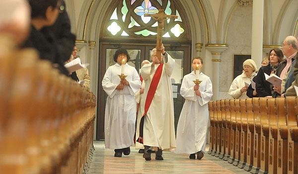 The Holy Cross is carried in procession up the aisle during Good Friday services at St. Joseph Cathedral
(Patrick McPartland/Staff Photographer)