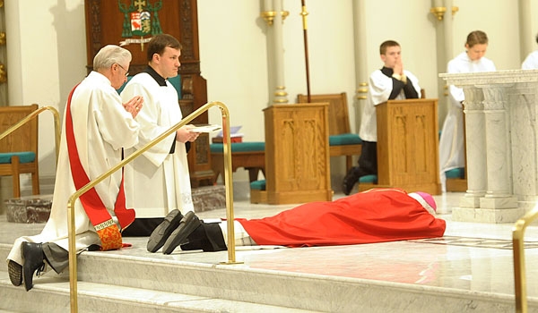 Bishop Richard J. Malone lies prostrate before the altar to begin Good Friday services at St. Joseph Cathedral
(Patrick McPartland/Staff Photographer)