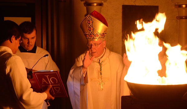 Bishop Richard J. Malone blesses the fire at the start of the Easter Vigil Mass at St. Joseph Cathedral. (Patrick McPartland)