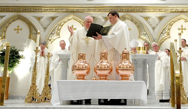 Bishop Richard J. Malone blesses the three oils during the Chrism Mass at St. Joseph Cathedral
(Patrick McPartland/Staff Photographer)