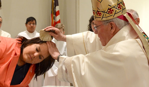 Carol Starr is baptized into the faith by Bishop Richard J. Malone during the Easter Vigil Mass at St. Joseph Cathedral. (Patrick McPartland)