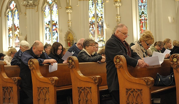 The congregation kneels at the conclusion of the Passion Narrative during Good Friday services at St. Joseph Cathedral
(Patrick McPartland/Staff Photographer)