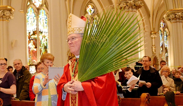 Bishop Richard J. Malone carries in palms during the opening procession at Palm Sunday Service at St. Joseph Cathedral.
(Kevin Keenan)