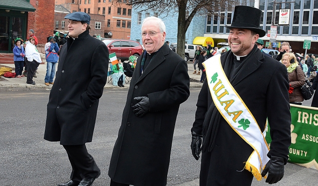 Father Ryszard Bierna, Bishop Richard J. Malone and Father David Richards help to lead the annual St. Patrick's Day Parade up Delaware Avenue in the City of Buffalo.
(Patrick McPartland/Staff Photographer)