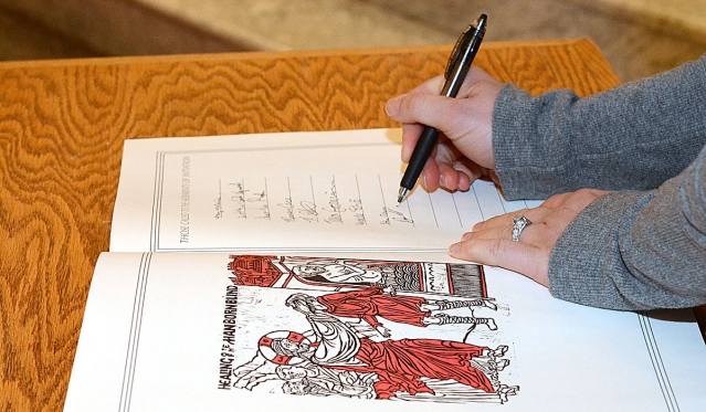 Names are added to the Book of the Elect at the annual Rite of Christian Initiation for Adults Mass. This year the Mass was held at St. Joseph Cathedral.
(Patrick McPartland/Staff Photographer)