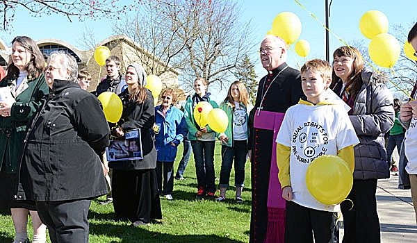 Patrick McPartland - Bishop Richard J. Malone joins with other marchers outside at the conclusion of the Rosary Novena for Life Mass at St. Rose of Lima Parish. The marchers then walked silently to pray outside a Main Street abortion clinic.