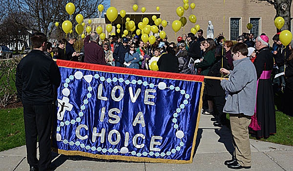 Patrick McPartland - Marchers gather outside at the conclusion of the Rosary Novena for Life Mass at St. Rose of Lima Parish. The marchers then proceeded to Main Street in Buffalo to pray outside an abortion clinic.