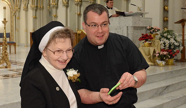 Jubilarian Sister Mary Bernadette Okulicz, FSSJ, poses for pictures with Father Jeff Nowak. Sr Bernadette celebrates her 50th jubilee in 2015 at St. Joseph Cathedral.
(Patrick McPartland/Staff Photographer)