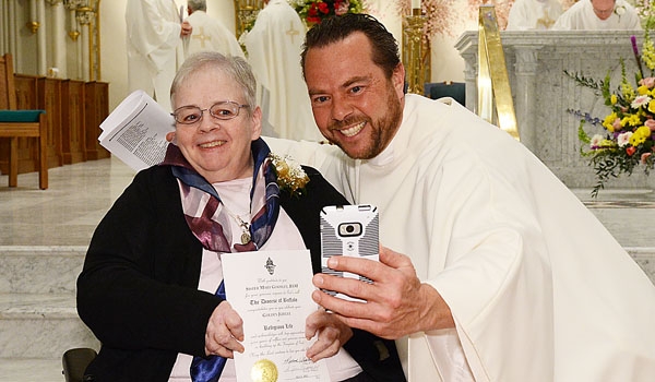  Jubilarian Sister Mary Gormley, RSM has a selfie taken with Father David Richards at the conclusion of the Jubilee 2015 and the Year of Consecrated Life at St. Joseph Cathedral.
(Patrick McPartland/Staff Photographer)