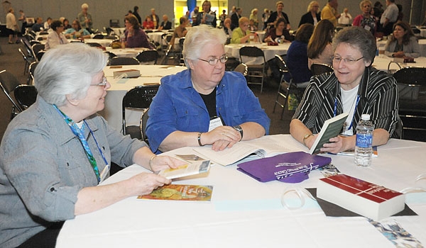 From Watertown, NY, Sister Ellen Rose Coughlin (left to right), SSJ, Sister Noel Chabanel Hentz SSJ, Sister Diane Marie Ulsamer SSJ discuss some of the items at the National Conference of Catechetical Leadership's (NCCL) national gathering in downtown Buffalo.
