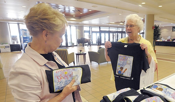 Diane Bruce (left) and Sister Ann Marie Kanusek, SND, from Cleveland check out the conference t-shirts at the National Conference of Catechetical Leadership's (NCCL) national gathering in downtown Buffalo.
(Patrick McPartland/Staff Photographer)