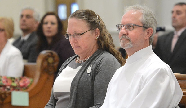 John Owczarczak is joined by his wife Barbara during the ordination to the diaconate at St. Joseph Cathedral.
(Patrick McPartland/Staff Photographer)