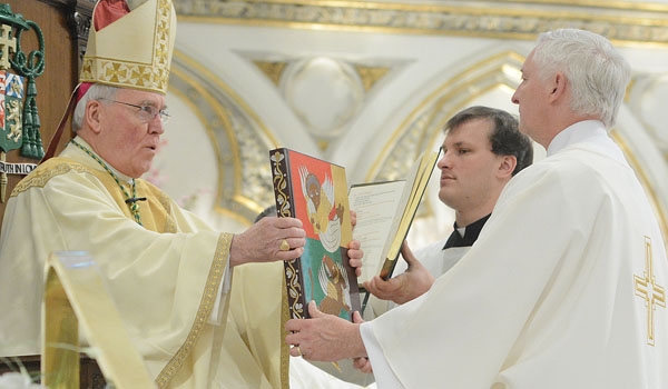 Bishop Richard J. Malone presents the Book of the Gospels to David Armstrong during ordination to the diaconate at St. Joseph Cathedral.
(Patrick McPartland/Staff Photographer)