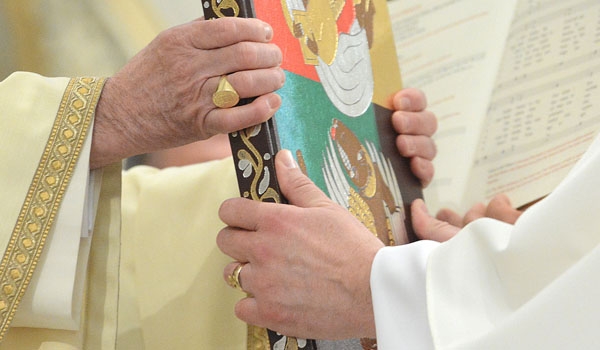 Bishop Richard J. Malone presents the Book of the Gospels to David Armstrong during ordination to the diaconate at St. Joseph Cathedral.
(Patrick McPartland/Staff Photographer)