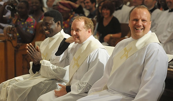 Ordini Daniel Ogbeifun (left to right), Thomas Mahoney and Lukasz Kopala share a laugh during their ordination to the priesthood. The ceremony took place at St. Joseph Cathedral.
(Patrick McPartland/Staff Photographer)