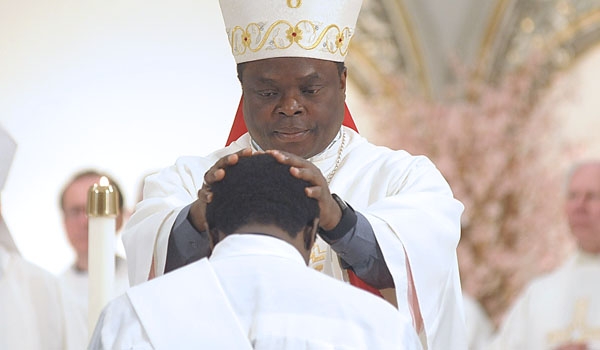 Bishop of Uromi Nigeria, Bishop Donates Ogun, lays his hands on the head of Daniel Ogbeifun during Ogbeifun's ordination to the priesthood. The ceremony took place at St. Joseph Cathedral.
(Patrick McPartland/Staff Photographer)