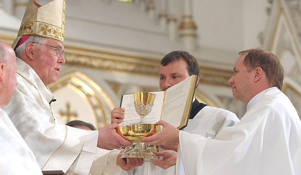 Bishop Richard J. Malone presents Thomas Mahoney with the bread and wine during his ordination to the priesthood. The ceremony took place at St. Joseph Cathedral.
(Patrick McPartland/Staff Photographer)