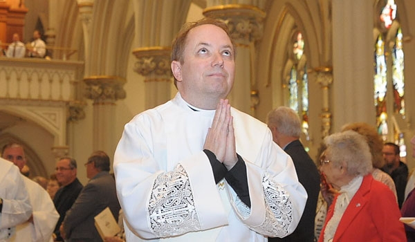 Ordini Thomas Mahoney looks to heaven as he processes down the main aisle during his ordination to the priesthood. The ceremony took place at St. Joseph Cathedral.
(Patrick McPartland/Staff Photographer)