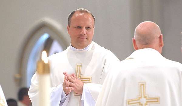 Father Lukasz Kopala awaits the sign of peace from his fellow priests after Kopala was ordination to the priesthood. The ceremony took place at St. Joseph Cathedral.
(Patrick McPartland/Staff Photographer)
