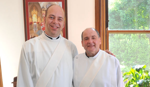 Bishop Malone then ordained two men - Bryan Zielenieski (left) and John Adams - at the cathedral on June 7, 2014.