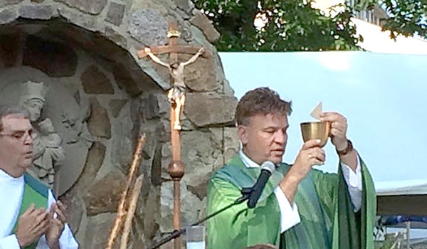 Afternoon Mass is held outside at the St. John Paul II Lawn Fete.