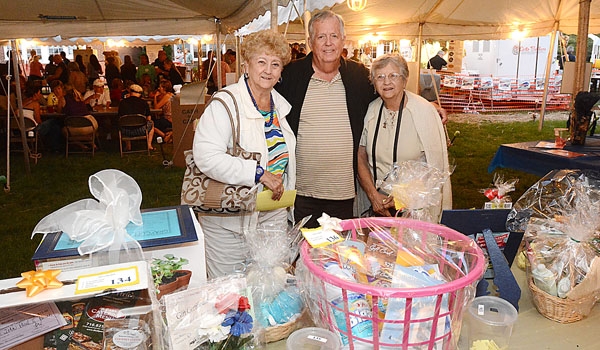 Marg Garlock (left to right), Patrick Garlock and Christine Ramsey try their luck at the basket raffle at the St. John Paul II Lawn Fete.