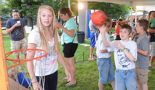 Nicholas Malinowski tries his hand at basketball at the St. John Paul II Lawn Fete.