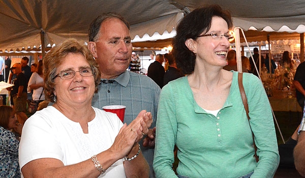 Chris Young (left to right),Dave Young and Christine Harlach enjoy the music at the St. John Paul II Lawn Fete.