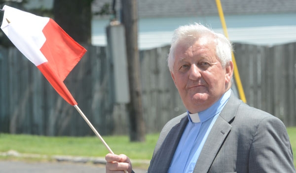 Father Thaddeus N. Bocianowski, marches down Harlem Road as part of the Pulaski Day Parade in Cheektowaga.