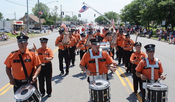 Pine Hill Drum Corps marches down Harlem Road as part of the Pulaski Day Parade in Cheektowaga.