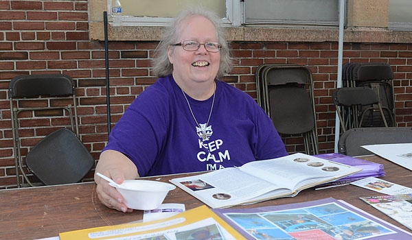 Susan Potaczaka works the Catholic Daughters of the Americas table at the Our Lady of Charity Summerfest.
(Patrick McPartland/Staff Photographer)