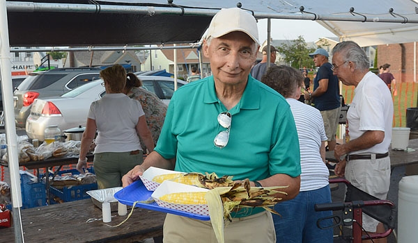 Bill Diehl gets ready to enjoy his grilled corn on the cob at the Our Lady of Charity Summerfest.
(Patrick McPartland/Staff Photographer)