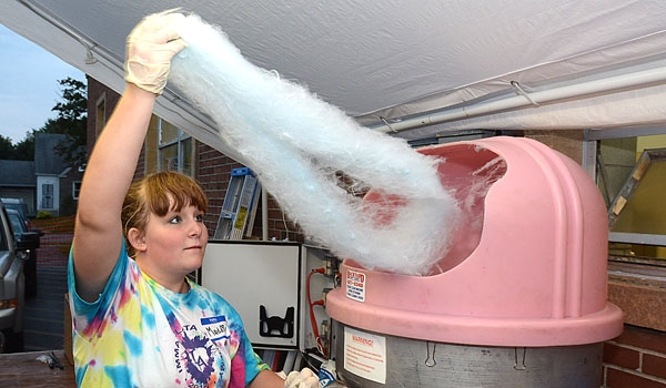 Madison Lauber serves up some cotton candy at the Our Lady of Charity Summerfest.
(Patrick McPartland/Staff Photographer)