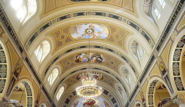 Newly restored murals line the center aisle during a Mass of Thanksgiving for the restoration of St. Joseph Church site.
(Patrick McPartland/Staff Photographer)