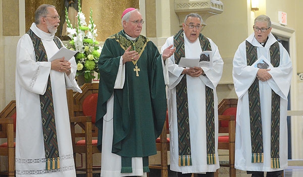 Bishop Richard J. Malone (center) thanks the congregation for the invitation to concelebrate Mass of Thanksgiving for the restoration of St. Joseph Church site. Joining Bishop Malone are Father John Graden (left to right) ,OSFS, Father Samuel Venne and Father Stewart Lindsay.
(Patrick McPartland/Staff Photographer)