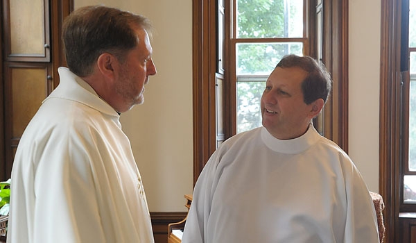 Transitional Deacon Michael Brown (right) chats with Father Robert Gebhard prior to Brown's ordination to the diaconate at St. Joseph Cathedral.
(Patrick McPartland/Staff Photographer)