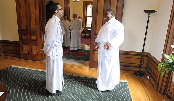 Transitional Deacons Samuel Giangreco and Venatius Agbasiere enjoy a light moment before ceremonies for ordination to the diaconate at St. Joseph Cathedral.
