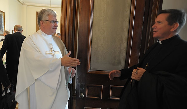 Father Joseph Gatto, President-Rector of Christ the King Seminary, greets attending clergy as they arrive to concelebrate the ordination to the diaconate at St. Joseph Cathedral.
(Patrick McPartland/Staff Photographer)