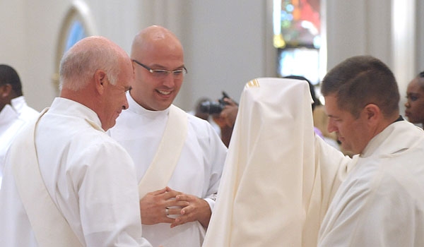 Bishop Richard J. Malone places his hands on the head of transitional deacon Samuel Giangreco during ceremonies for ordination to the diaconate at St. Joseph Cathedral.
(Patrick McPartland/Staff Photographer)